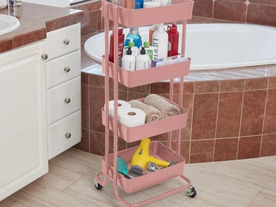 pink metal storage cart full of bath products in bathroom