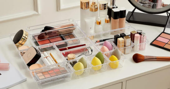 clear organizers holding cosmetics on bathroom counter
