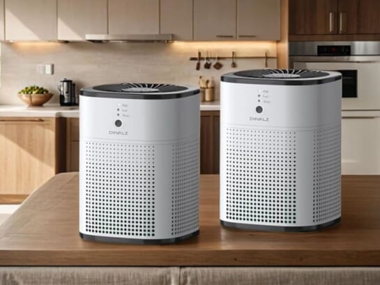 Two air purifiers displayed on top of a table near the kitchen