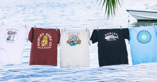 hurley graphic tees hanging on a clothesline near beach