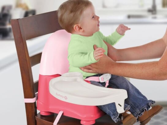 Adult taking a baby out of Safety 1st Booster Seat