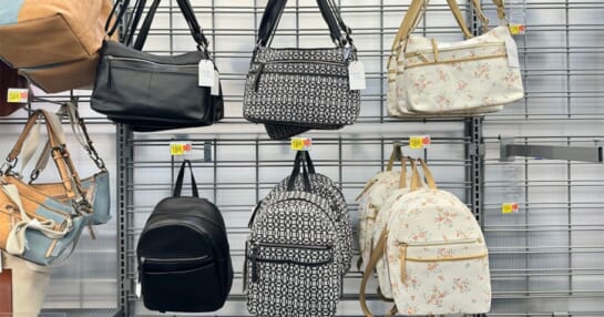 three shoulder bags and three backpacks hanging on shelf in walmart